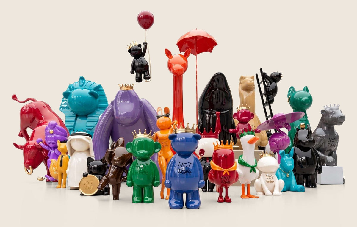 The NOT TOYS family: Fudge, Gigi, Coco, Kobe, Sky and the other characters together in the sand studio