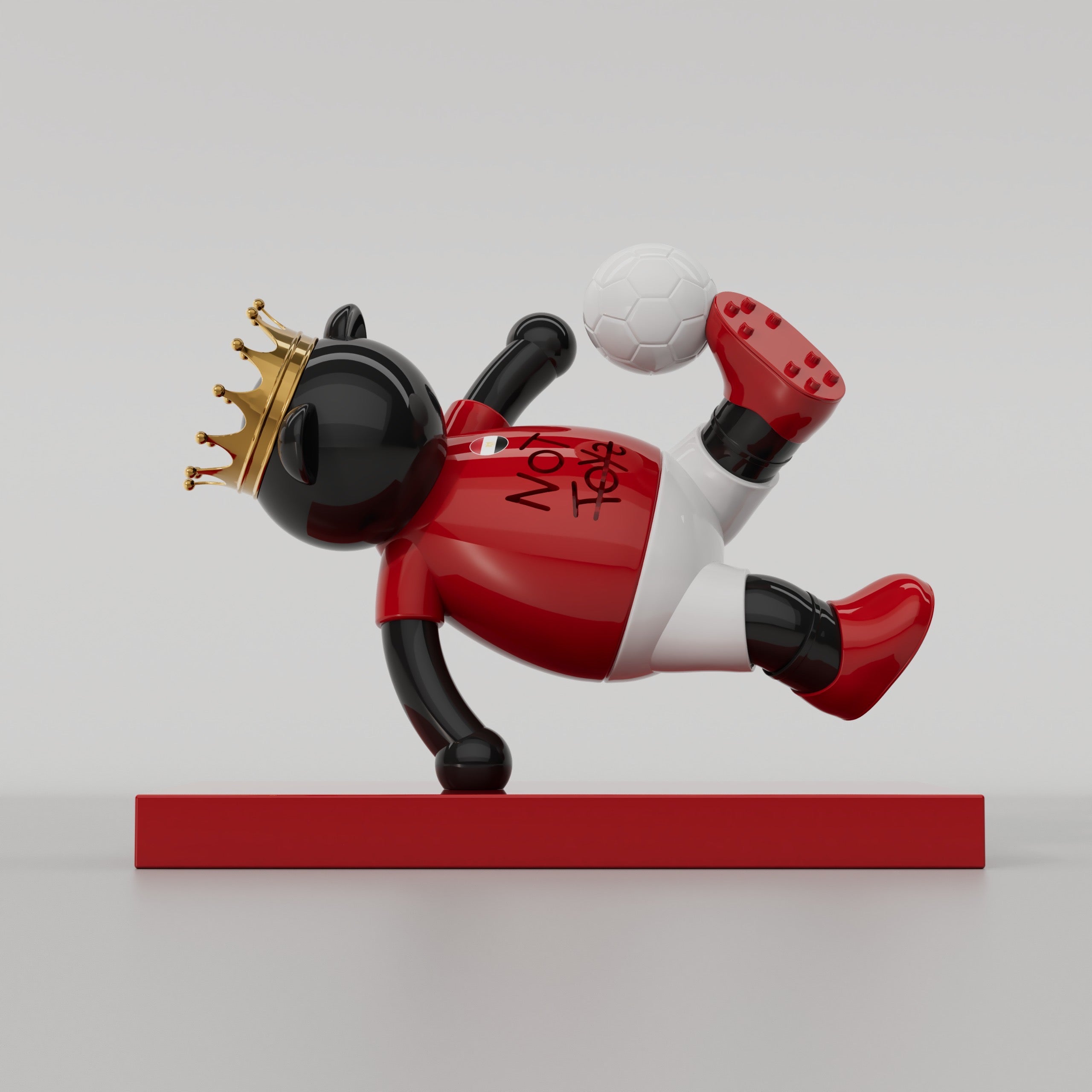 FUDGE football sculpture in Egypt colors balancing a football
